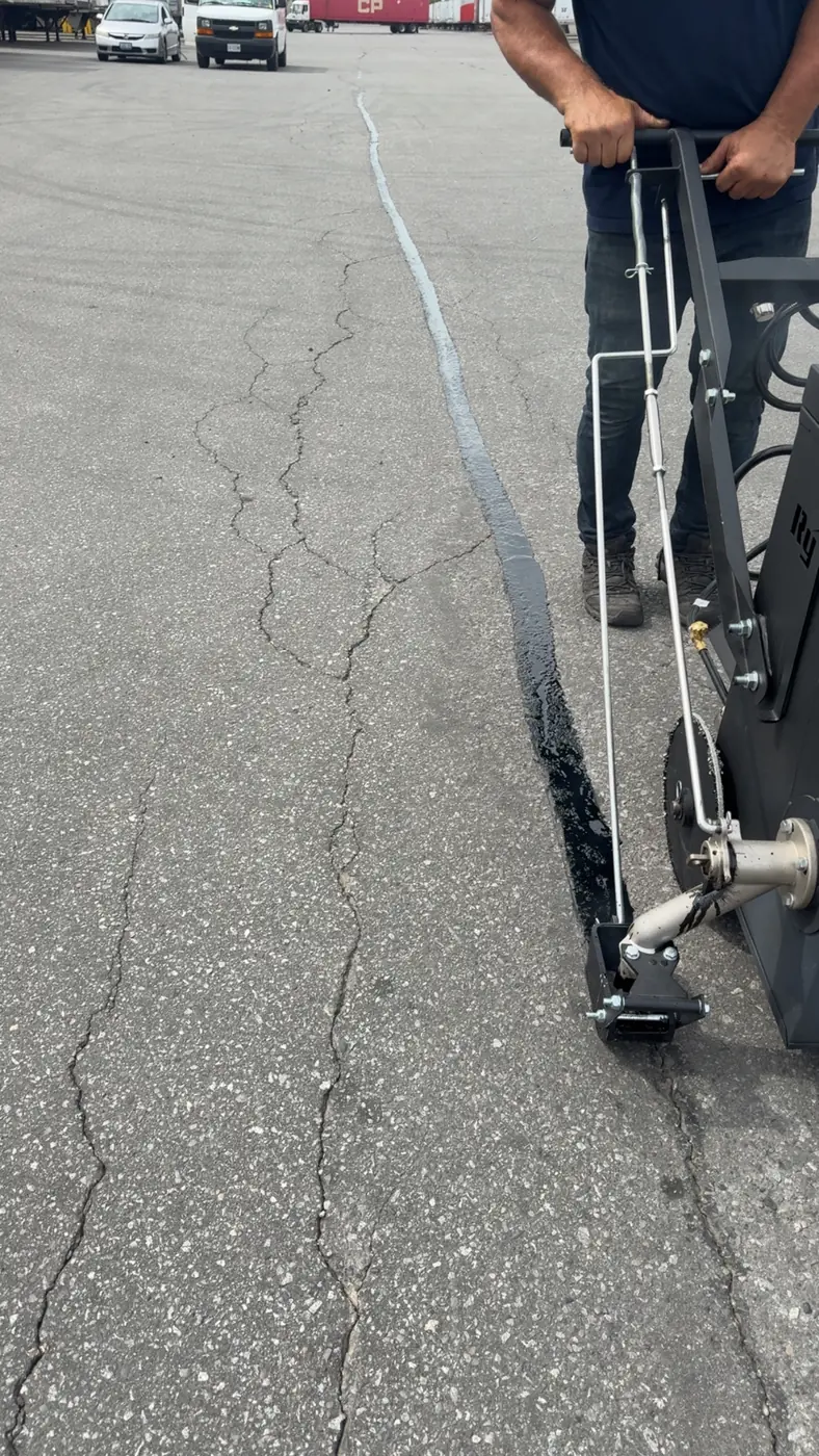 Commercial hot-rubber crack filling machine applying sealant