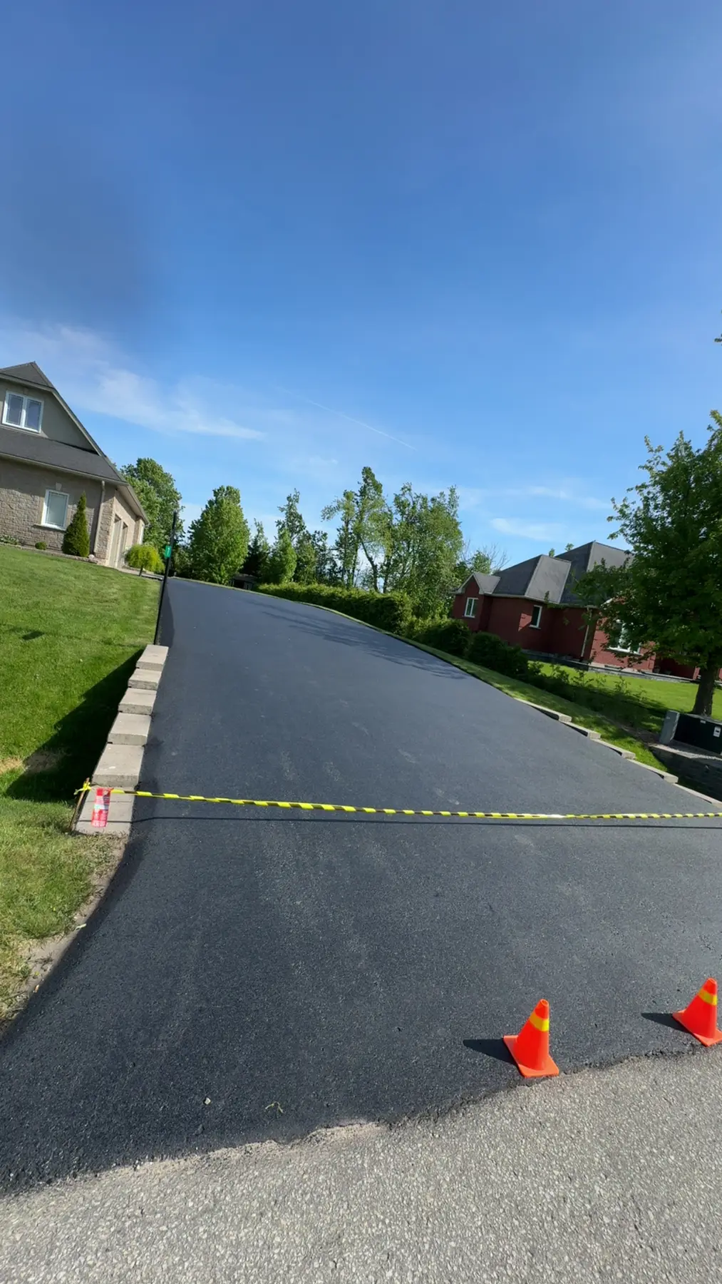 Large residential driveway after professional asphalt sealing